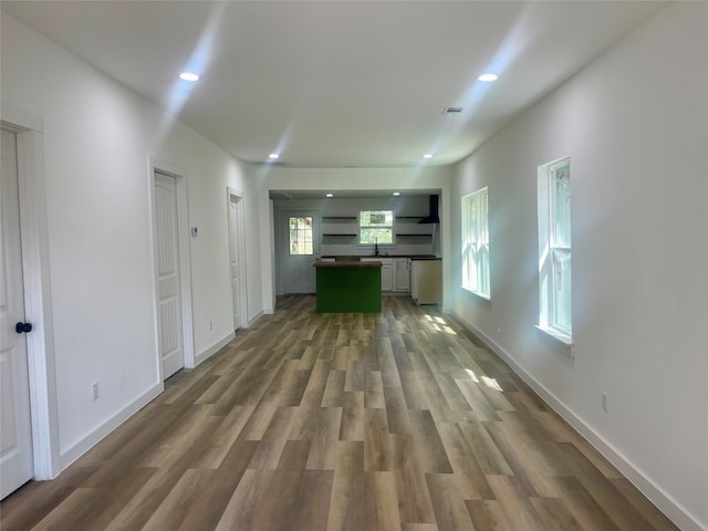 unfurnished living room with dark wood-type flooring and sink