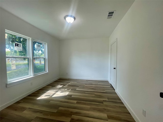 unfurnished room with dark hardwood / wood-style floors