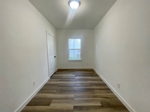 empty room featuring dark wood-type flooring