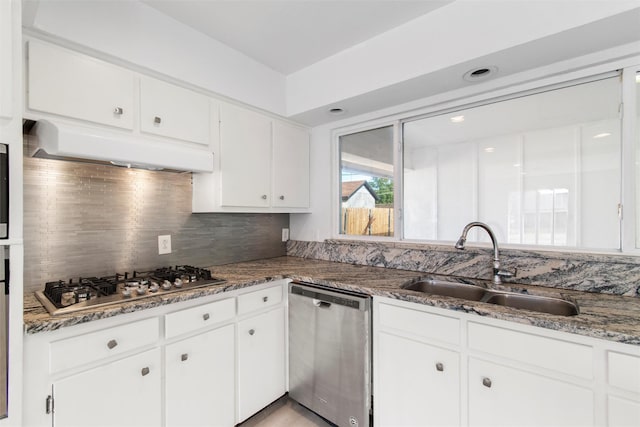 kitchen with sink, white cabinetry, stainless steel appliances, and dark stone counters