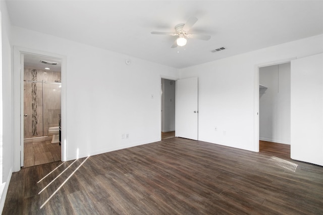 unfurnished bedroom featuring ensuite bathroom, dark hardwood / wood-style floors, and ceiling fan