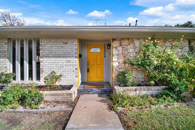 property entrance with brick siding