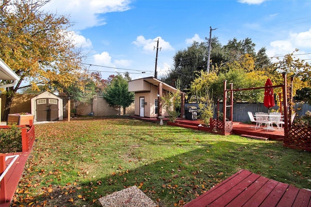 view of yard featuring a shed and a wooden deck