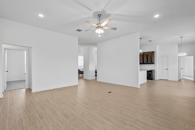 unfurnished living room featuring light hardwood / wood-style flooring and ceiling fan