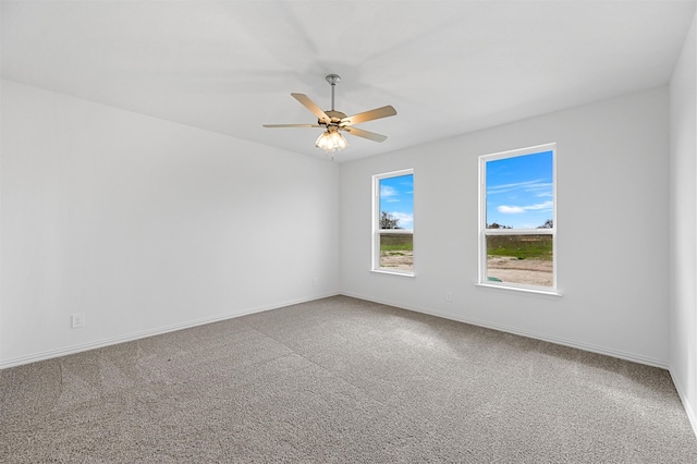 spare room featuring carpet and ceiling fan