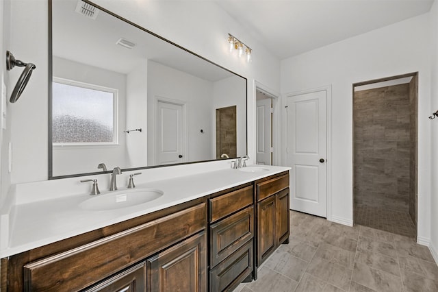 bathroom with vanity and a shower