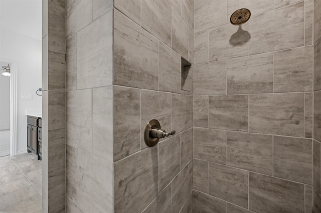 details featuring a tile shower and vanity