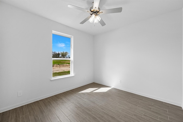 spare room featuring hardwood / wood-style floors and ceiling fan