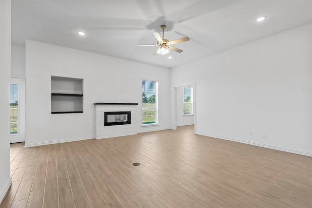 unfurnished living room featuring ceiling fan and light wood-type flooring