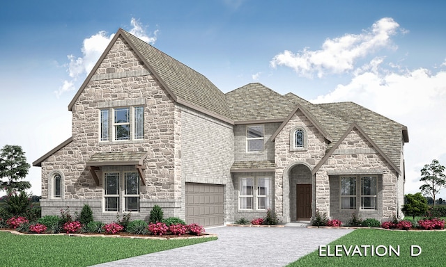 view of front of home with a garage and a front lawn