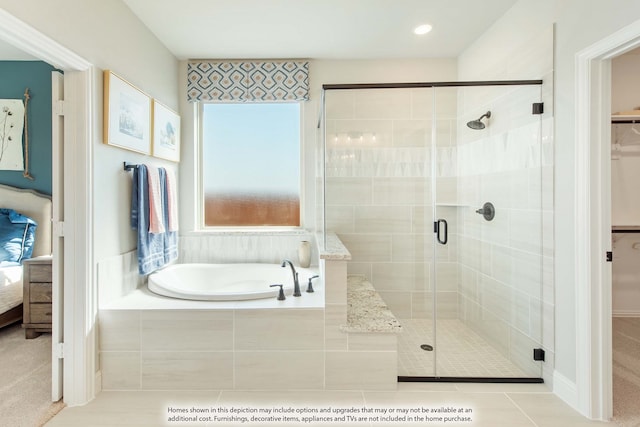 bathroom featuring tile patterned flooring and independent shower and bath