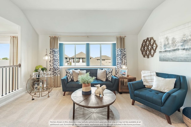 carpeted living room with lofted ceiling and plenty of natural light