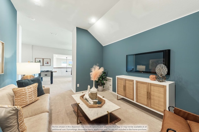 carpeted living room featuring vaulted ceiling