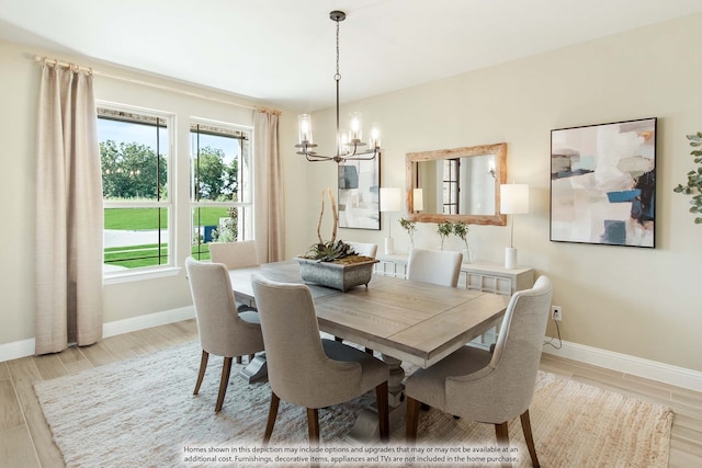 dining room featuring light hardwood / wood-style flooring and an inviting chandelier