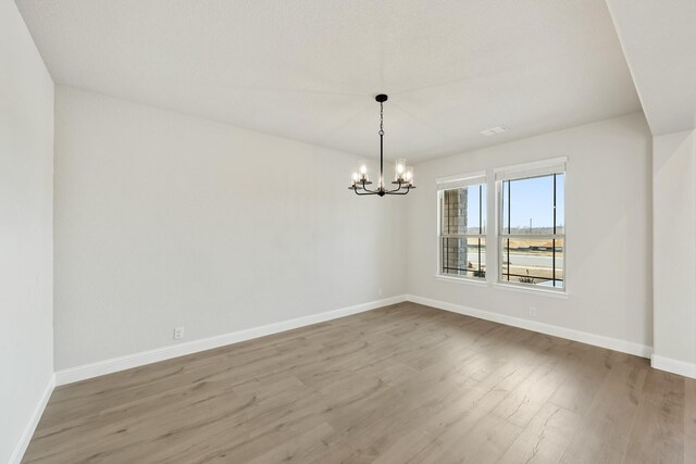 dining area featuring light hardwood / wood-style flooring and a notable chandelier