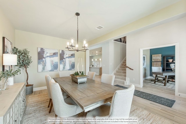 dining space with an inviting chandelier and light wood-type flooring