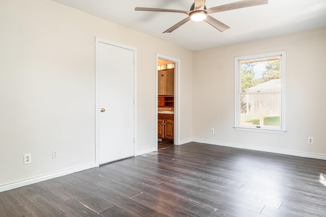 empty room featuring dark hardwood / wood-style floors and ceiling fan