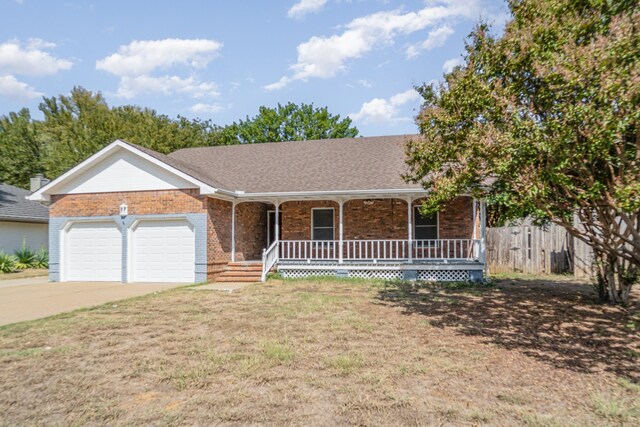 single story home with a front yard, a porch, and a garage