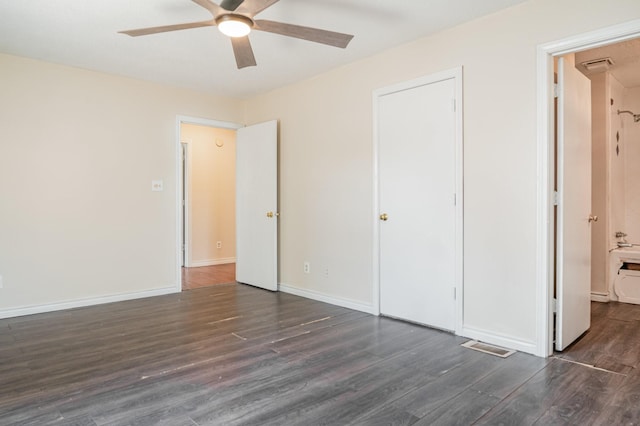 unfurnished bedroom featuring ceiling fan and dark hardwood / wood-style flooring