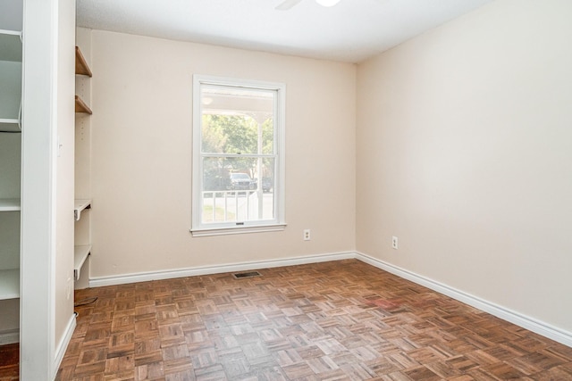 spare room featuring dark parquet floors