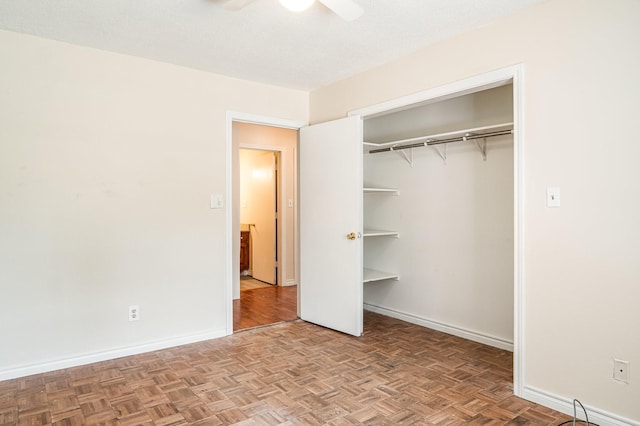 unfurnished bedroom featuring ceiling fan, light parquet floors, and a textured ceiling