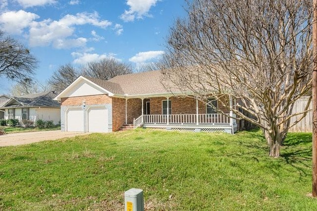 single story home featuring driveway, covered porch, a front yard, a garage, and brick siding