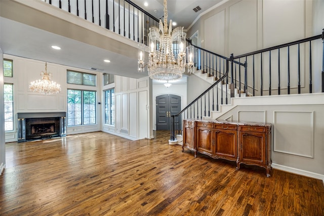 entryway with dark wood-type flooring and a high ceiling