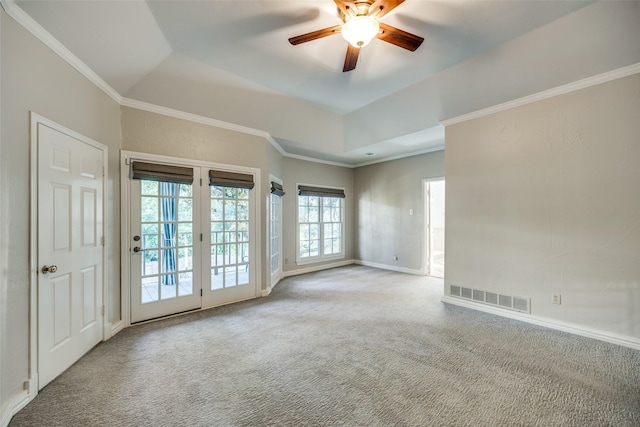 carpeted empty room with ceiling fan and crown molding