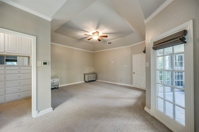 empty room featuring light colored carpet, ceiling fan, and ornamental molding