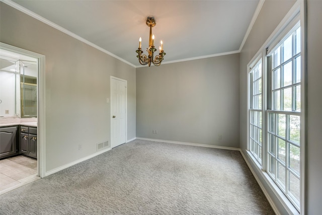 empty room with a chandelier, light colored carpet, and ornamental molding