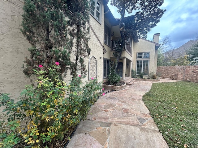 rear view of property featuring a mountain view and a lawn