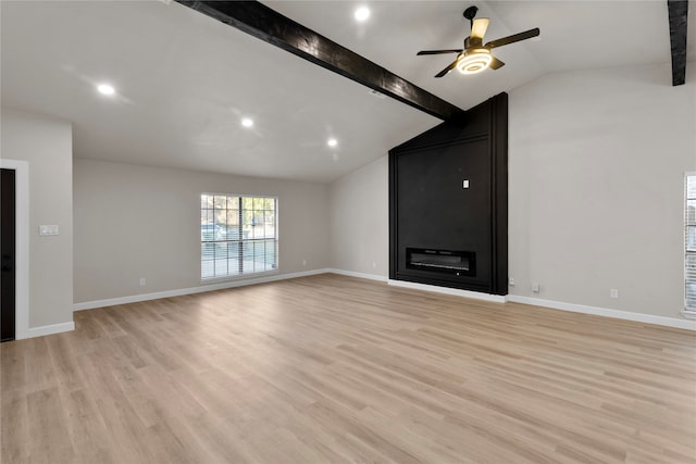 unfurnished living room featuring vaulted ceiling with beams, ceiling fan, light hardwood / wood-style flooring, and a fireplace