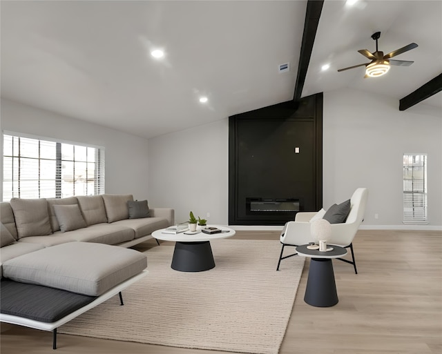 living room with lofted ceiling with beams, light hardwood / wood-style floors, and ceiling fan