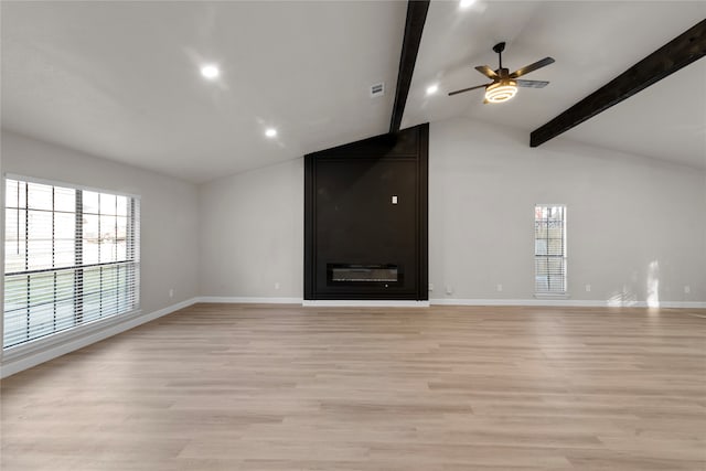 unfurnished living room featuring lofted ceiling with beams, light hardwood / wood-style floors, and ceiling fan