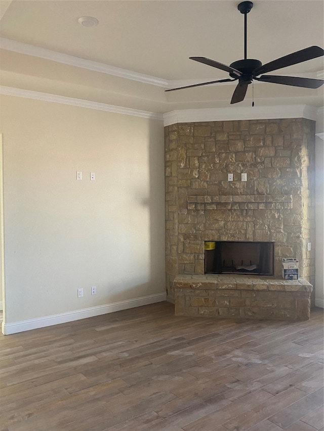 unfurnished living room with crown molding, a fireplace, ceiling fan, and hardwood / wood-style flooring