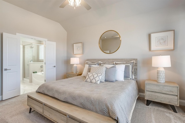 carpeted bedroom with connected bathroom, lofted ceiling, and ceiling fan