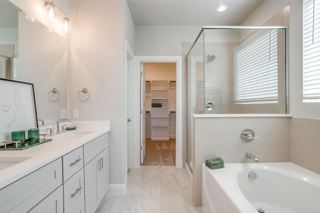 bathroom featuring plus walk in shower and vanity