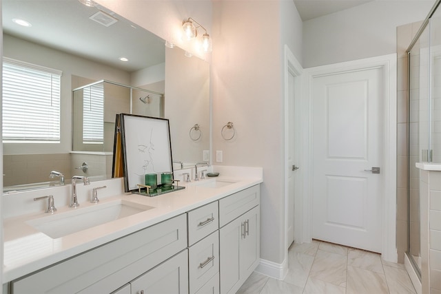 bathroom with vanity and a shower with shower door