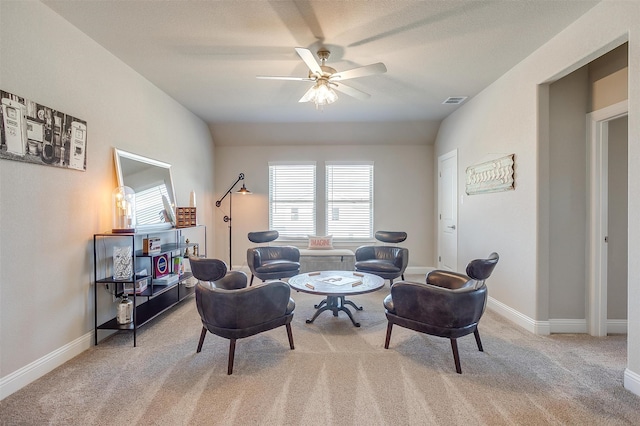 sitting room featuring light carpet and ceiling fan