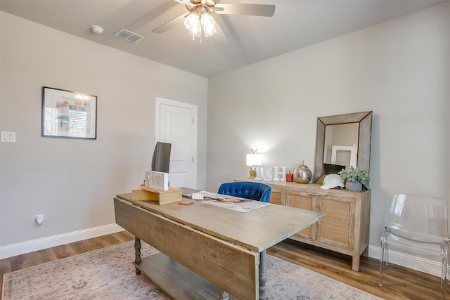 home office with ceiling fan and hardwood / wood-style floors