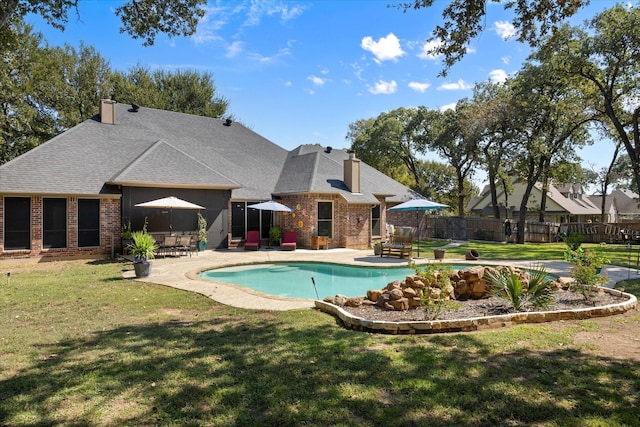 view of swimming pool with a patio area and a yard