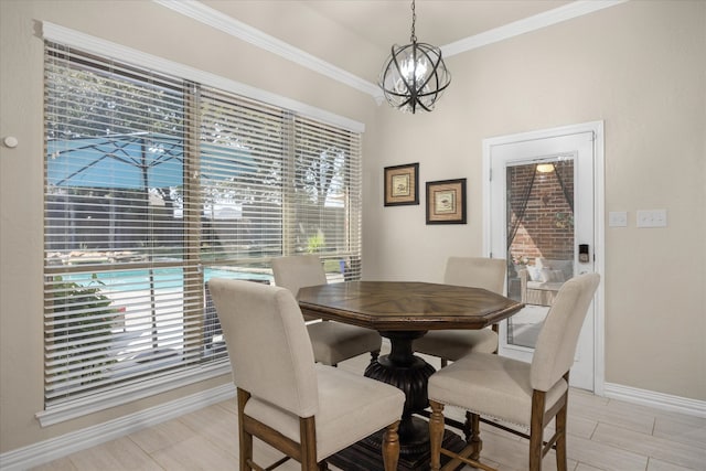 dining space with crown molding and a chandelier