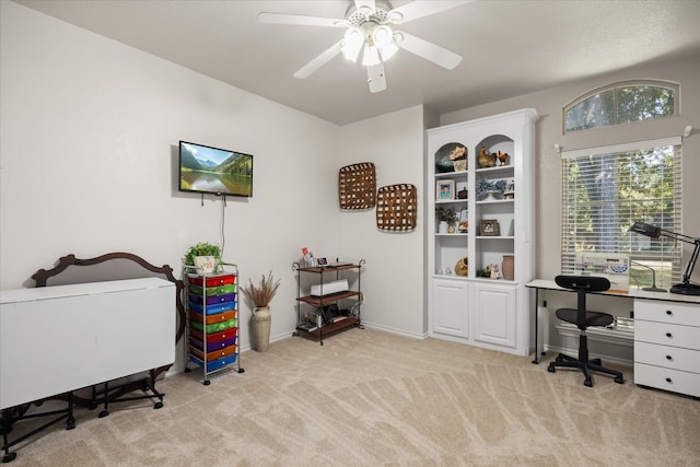 carpeted office space with ceiling fan