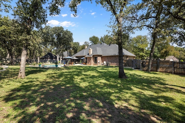 view of yard with a fenced in pool and a patio area