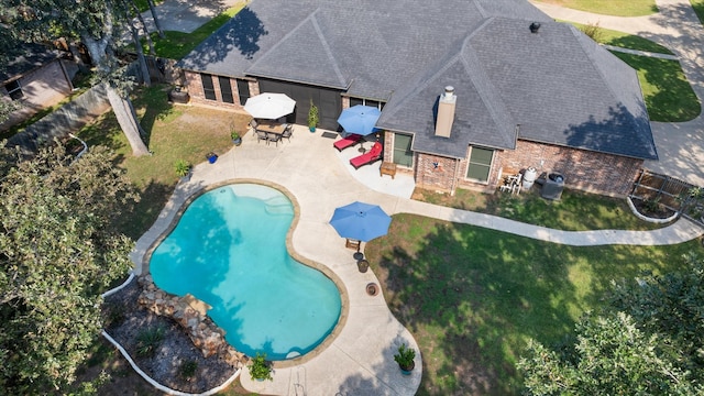 view of pool featuring a patio area and a lawn