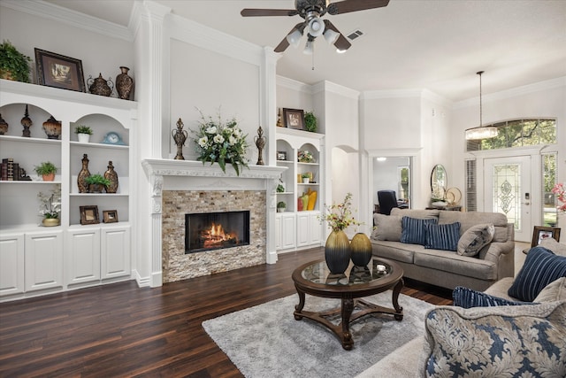 living room featuring built in shelves, ceiling fan, a fireplace, and dark hardwood / wood-style flooring