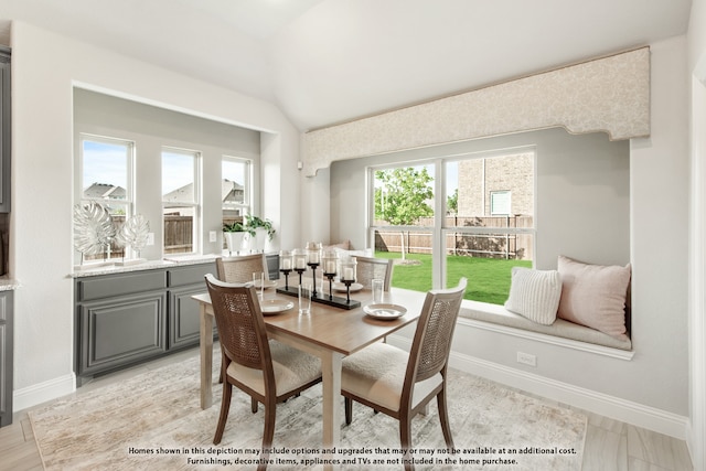 dining area with lofted ceiling and plenty of natural light