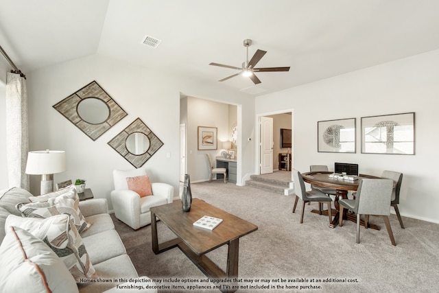 carpeted living room with vaulted ceiling and ceiling fan