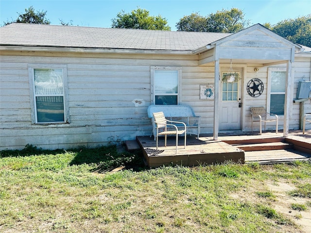 exterior space featuring a wooden deck and a lawn