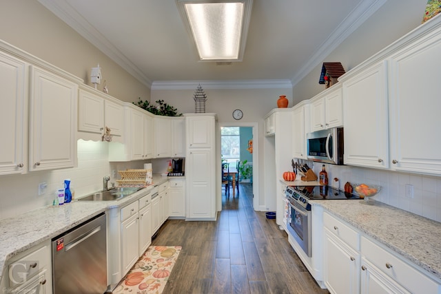 kitchen featuring ornamental molding, dark hardwood / wood-style floors, stainless steel appliances, and white cabinets